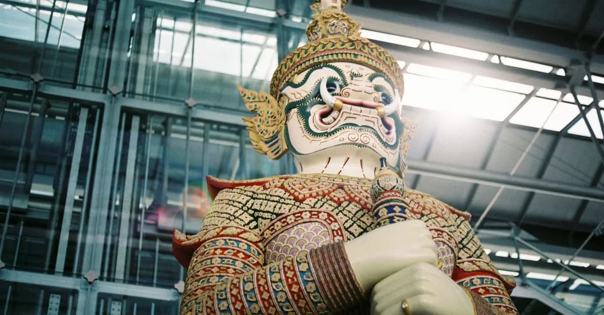 Colorful guardian statue at Bangkok airport, showcasing Thai cultural art.