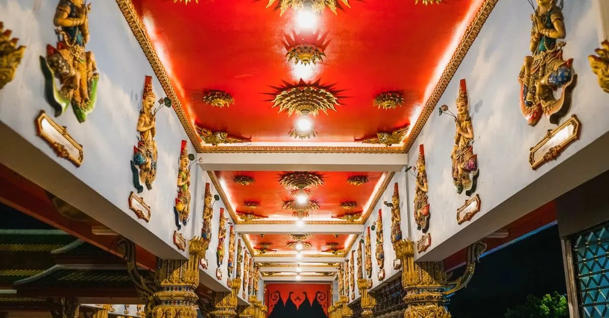 Explore the ornate Buddhist temple interior with vibrant sculptures and golden decor in Nonthaburi, Thailand.