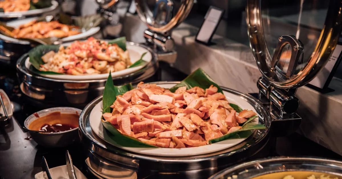 A sumptuous buffet with assorted meats and rice served in a luxurious setting.
