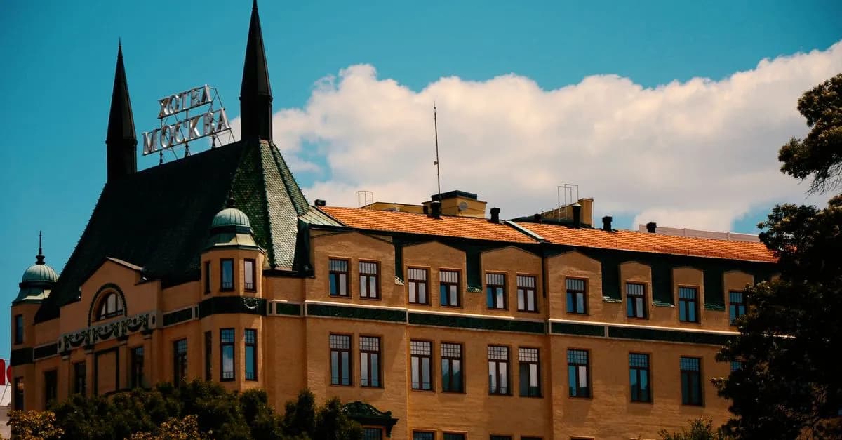 Historic hotel building with pointed spires and clear sky backdrop.