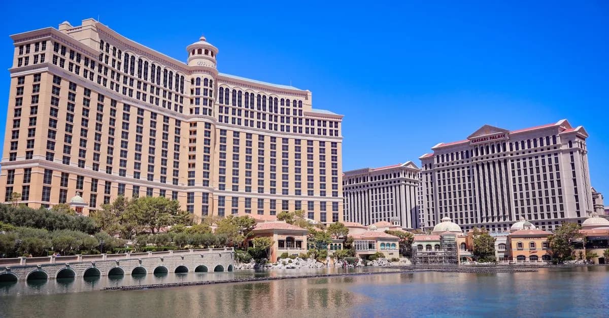 Stunning daylight view of the Bellagio and Caesars Palace in Las Vegas with a clear blue sky and reflective waters.