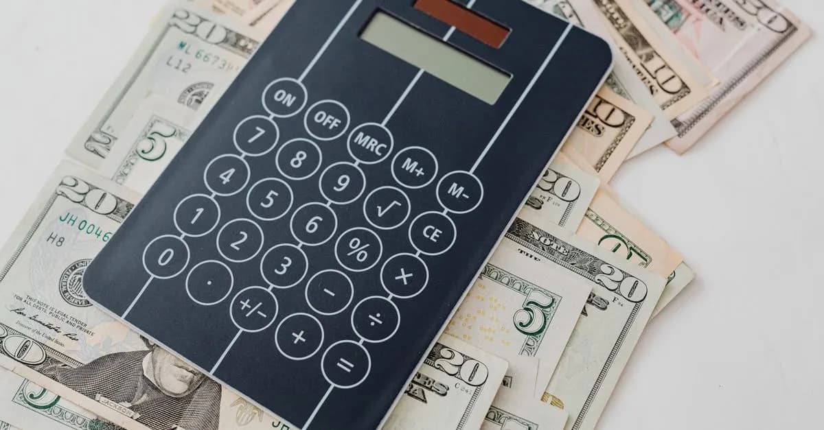 Close-up of a calculator atop US dollar bills, symbolizing financial planning and budgeting.